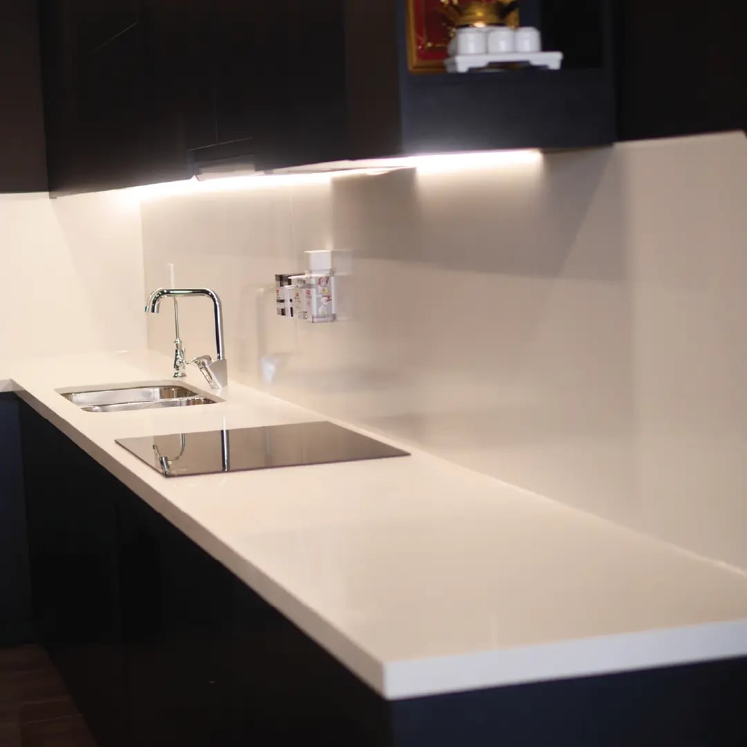 Tấm ốp thép tráng men trắng hoàn thiện dưới đèn tủ treo, bếp căn hộ Urban Green
